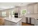 Stylish kitchen featuring stainless steel appliances, white cabinets, island and eat in area at 1229 Dimaggio Dr # 8, Raleigh, NC 27616