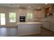 Modern kitchen featuring an island with white countertops, stainless steel appliances, recessed lighting, and wood floors at 1229 Dimaggio Dr # 8, Raleigh, NC 27616