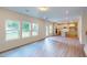 Spacious open-concept living room with hardwood floors, recessed lighting, large windows, and an eat-in kitchen at 1229 Dimaggio Dr # 8, Raleigh, NC 27616