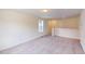 An open room with plush carpet, bright walls, and a window for natural light at 1229 Dimaggio Dr # 8, Raleigh, NC 27616