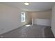 Open room with neutral walls, carpet, and a window providing a view of the outdoors at 1229 Dimaggio Dr # 8, Raleigh, NC 27616