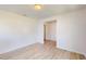 An open room featuring sleek hardwood floors, white walls and trim, and modern ceiling light at 1229 Dimaggio Dr # 8, Raleigh, NC 27616