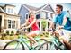 Couple rides bikes on street with beautiful neighborhood homes at 1250 Barreto Dr, Wendell, NC 27591