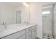Bathroom features double vanity, quarts counters, star patterned tile floors, and glass enclosed shower at 1250 Barreto Dr, Wendell, NC 27591