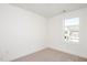 Neutral carpeted bedroom features a single window with a view of the adjacent homes at 1250 Barreto Dr, Wendell, NC 27591