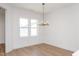 Bright dining area with ample natural light and stylish light fixture complements the wood flooring at 1250 Barreto Dr, Wendell, NC 27591