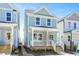 Charming two-story home features a covered front porch and a light blue exterior with white trim at 1250 Barreto Dr, Wendell, NC 27591