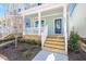Inviting front porch with white railings and a charming blue front door with newly installed wooden steps at 1250 Barreto Dr, Wendell, NC 27591