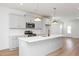 Modern kitchen with a large central island, pendant lighting, and stainless steel appliances at 1250 Barreto Dr, Wendell, NC 27591
