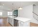 Contemporary kitchen featuring a large island with modern fixtures that connects to the living room area at 1250 Barreto Dr, Wendell, NC 27591