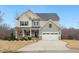 Charming two-story home with a two-car garage, inviting front porch, and neutral color palette at 130 Neuse Overlook Dr, Clayton, NC 27527