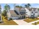 Aerial view of a two-story home, a two-car garage, covered porch, landscaping and For Sale sign at 1311 Arena Ln, Fuquay Varina, NC 27526