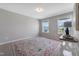 Bright bedroom with neutral walls, large windows, and a patterned area rug at 1311 Arena Ln, Fuquay Varina, NC 27526