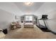 Bonus room has a comfortable sectional sofa, carpeted floors and a treadmill at 1311 Arena Ln, Fuquay Varina, NC 27526