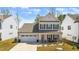 Beautiful two-story home with a two-car garage, covered porch and manicured landscaping at 1311 Arena Ln, Fuquay Varina, NC 27526