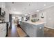 Bright, open kitchen featuring a large center island with gray cabinets and modern pendant lighting at 1311 Arena Ln, Fuquay Varina, NC 27526