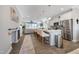 Open concept kitchen features a large island, white cabinets, and stainless steel appliances at 1311 Arena Ln, Fuquay Varina, NC 27526