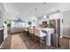Open-concept kitchen featuring a large island with seating, stainless steel appliances, and modern finishes at 1311 Arena Ln, Fuquay Varina, NC 27526