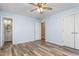 Spacious bedroom featuring hardwood floors, a ceiling fan and access to the ensuite bathroom and closet at 1317 Long Dairy Ct, Graham, NC 27253