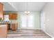 Bright dining area with wood-look flooring, adjacent to the kitchen, featuring French doors and plenty of natural light at 1317 Long Dairy Ct, Graham, NC 27253