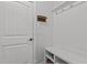 Mudroom with coat hooks, bench seating and storage shelves near the door at 1403 Medici Ct, Cary, NC 27518