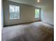 Spacious carpeted bedroom with natural lighting from two windows at 144 Parker Ln, Mebane, NC 27302