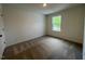 Carpeted bedroom with a window providing natural light at 144 Parker Ln, Mebane, NC 27302