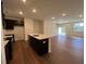 Stylish kitchen features an island, dark cabinets, and an open floor plan at 144 Parker Ln, Mebane, NC 27302