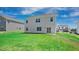 Grassy backyard with a view of the home's exterior and neighboring properties at 156 Paper Birch Way, Fuquay Varina, NC 27526