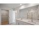 Bright bathroom features double sink vanity with white countertops and a glass enclosed shower at 156 Paper Birch Way, Fuquay Varina, NC 27526