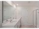 Bright bathroom features double sink vanity with white countertops and a glass enclosed shower at 156 Paper Birch Way, Fuquay Varina, NC 27526