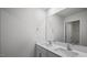 Modern bathroom features dual sinks with white quartz counters and a large mirror at 156 Paper Birch Way, Fuquay Varina, NC 27526