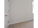 Neutral bedroom with neutral carpet, light walls, door, and a window for natural light at 156 Paper Birch Way, Fuquay Varina, NC 27526