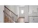 Bright foyer with hardwood floors, a staircase with wood railing, and white trim throughout at 156 Paper Birch Way, Fuquay Varina, NC 27526