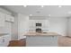 Modern kitchen with granite countertops, stainless steel appliances, and a central island at 156 Paper Birch Way, Fuquay Varina, NC 27526