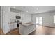 Modern kitchen with granite countertops, stainless steel appliances, central island, and wood floors at 156 Paper Birch Way, Fuquay Varina, NC 27526