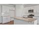 Modern kitchen with granite countertops, stainless steel appliances, and a central island sink at 156 Paper Birch Way, Fuquay Varina, NC 27526