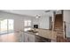 Open concept kitchen with granite island, stainless dishwasher, and view of the fireplace at 156 Paper Birch Way, Fuquay Varina, NC 27526