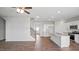 Bright open-concept living area with a kitchen island, stainless steel appliances, and staircase at 156 Paper Birch Way, Fuquay Varina, NC 27526