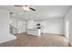 Open-concept living room showcasing a kitchen island, fireplace, and bright natural light at 156 Paper Birch Way, Fuquay Varina, NC 27526