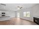 Open-concept living room featuring a fireplace, ceiling fan and an island kitchen at 156 Paper Birch Way, Fuquay Varina, NC 27526
