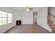 Spacious living room featuring a cozy fireplace, large window, and staircase access at 156 Paper Birch Way, Fuquay Varina, NC 27526