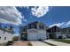 Charming townhome with blue and gray exterior, showcasing a well-maintained yard on a sunny day at 160 Parker Ln, Mebane, NC 27302