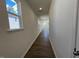 Bright hallway featuring hardwood floors and natural light streaming through the windows at 160 Parker Ln, Mebane, NC 27302