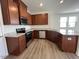 Stylish kitchen with stainless steel appliances, dark wood cabinets, and granite countertops at 160 Parker Ln, Mebane, NC 27302