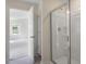Bathroom featuring a glass shower and open doorway to a bedroom at 168 Paper Birch Way, Fuquay Varina, NC 27526