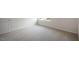 A clean bedroom with neutral carpeting and a bright window at 168 Paper Birch Way, Fuquay Varina, NC 27526