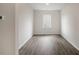 Bright, empty room featuring wood floors, natural light from the window, and neutral walls at 168 Paper Birch Way, Fuquay Varina, NC 27526