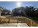 Decking overlooks a backyard with lovely mature trees at 175 Magnolia Run Way, Benson, NC 27504