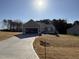 Charming one-story home with an open garage, concrete driveway, and a well-maintained lawn on a sunny day at 175 Magnolia Run Way, Benson, NC 27504